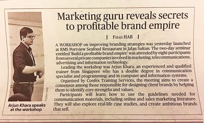 Newspaper article featuring Arjun Khara as a marketing guru, giving a talk on building a profitable brand empire