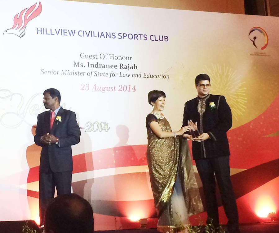 Arjun Khara receiving an award from the Minister of State for his design and management services to the Silent Heroes Award in Singapore