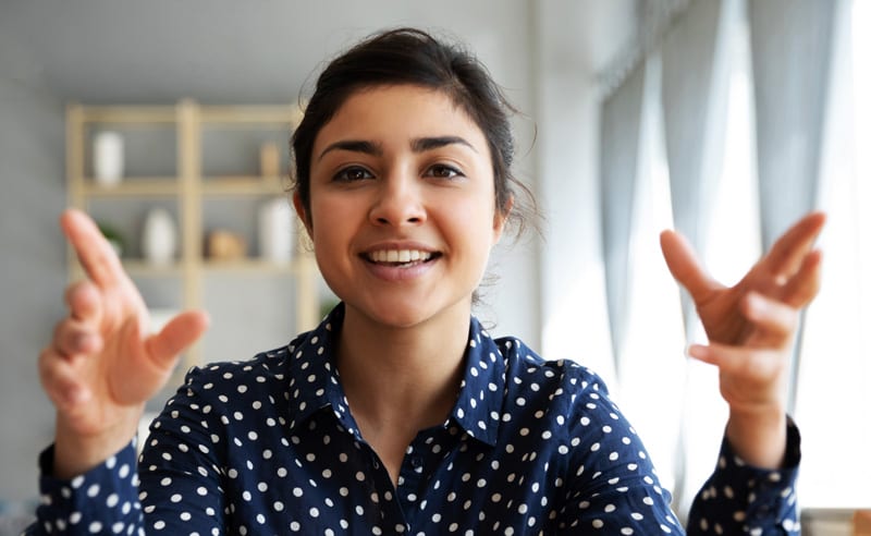 A young Indian woman conducting an online seminar for a content marketing course in Singapore.